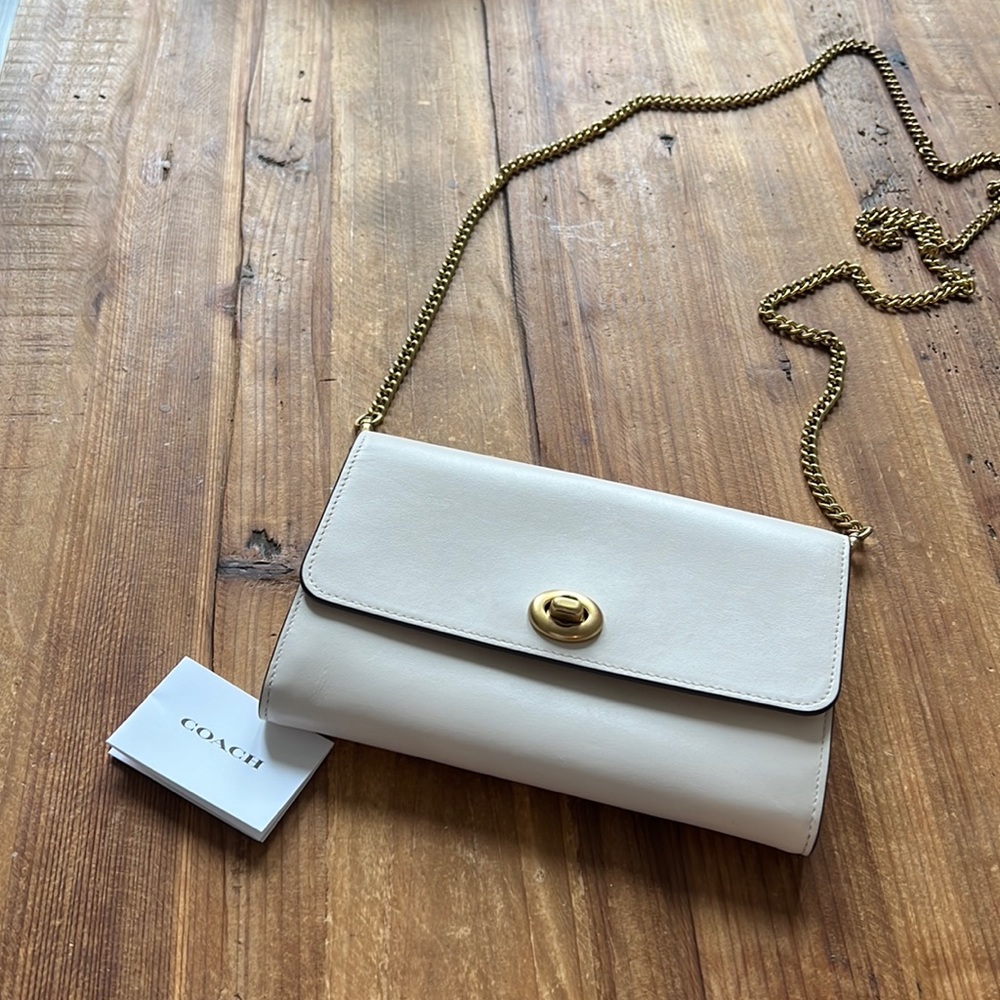 Small white Coach clutch with gold chain strap
